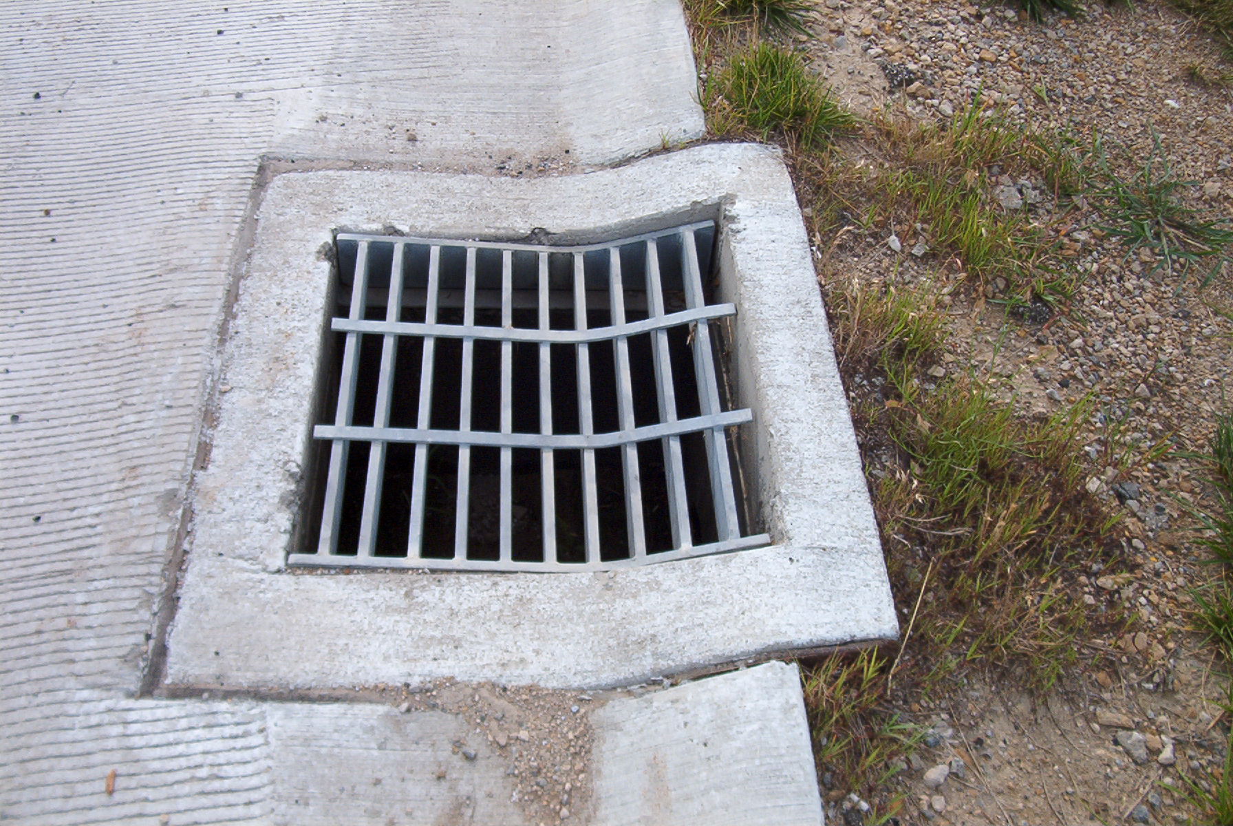 Steel bar grate in a drainage ditch.
